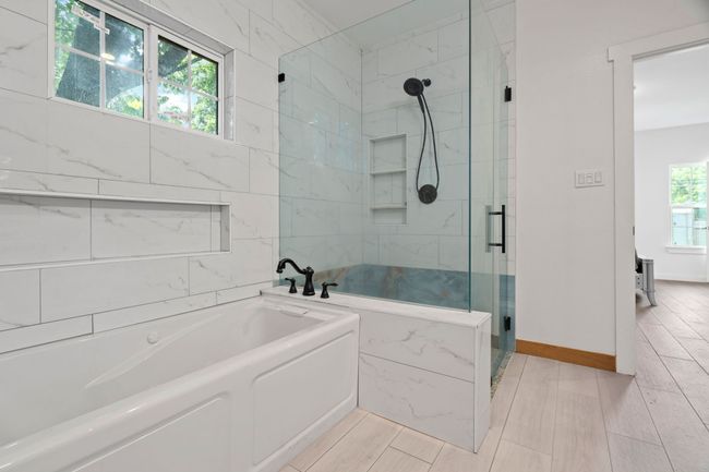 Full bath featuring a stall shower and a garden tub | Image 27