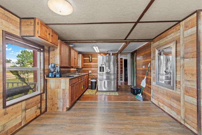 Nearby, a newer 800 sq ft duplex features two fully outfitted 400 sq ft units—each with a kitchen, tiled bath, and washer/dryer hookups—offering flexible guest or rental options. | Image 21