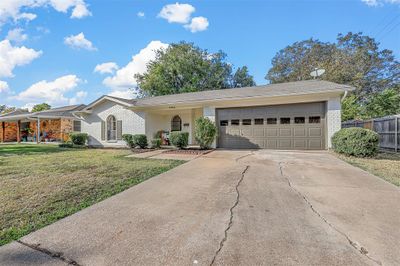 Ranch-style house featuring a front lawn and a garage | Image 3