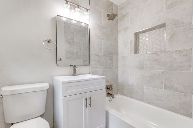 Bathroom featuring vanity and shower / bath combination | Image 23
