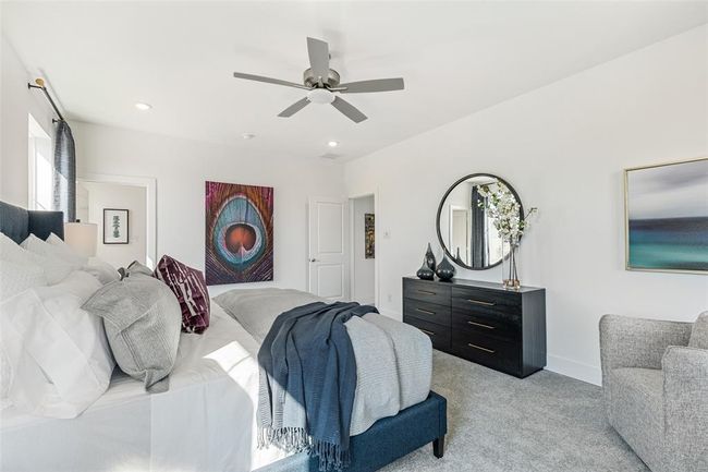 Bedroom with ceiling fan and light carpet | Image 23