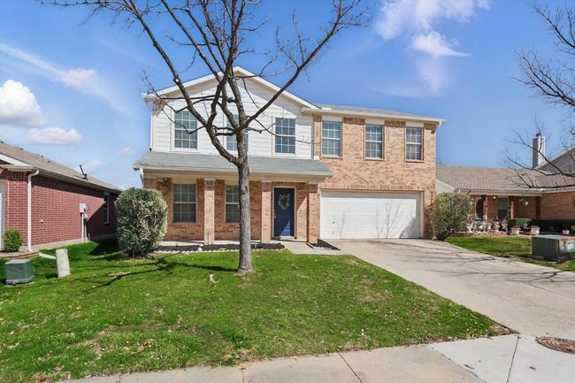 Traditional-style house with brick siding, driveway, an attached garage, and a front yard | Image 5