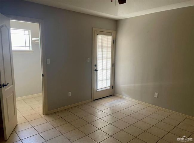 Spare room with light tile patterned floors, a ceiling fan, and baseboards | Image 5