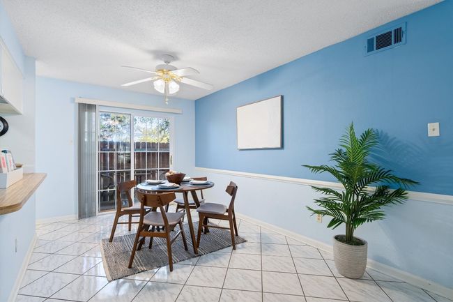 Dining area featuring baseboards, visible vents, a textured ceiling, and a ceiling fan | Image 10