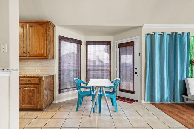 Dining space with light tile patterned flooring | Image 13