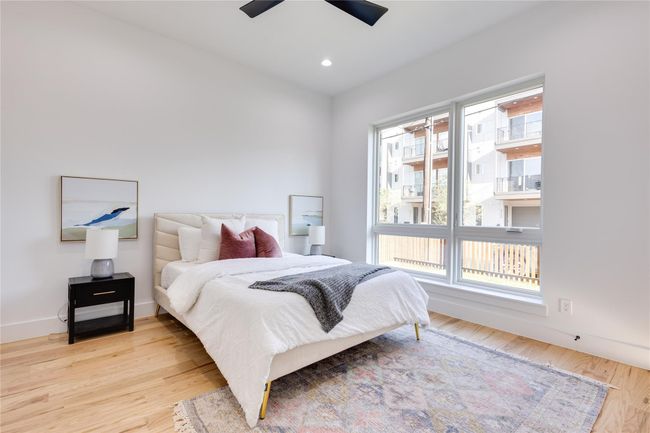 Bedroom with multiple windows, ceiling fan, and light hardwood / wood-style floors | Image 9