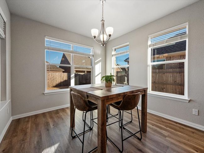 Dining space featuring baseboards, a chandelier, and dark wood finished floors | Image 8