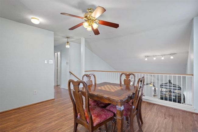 Dining space featuring ceiling fan, vaulted ceiling, and wood finished floors | Image 17