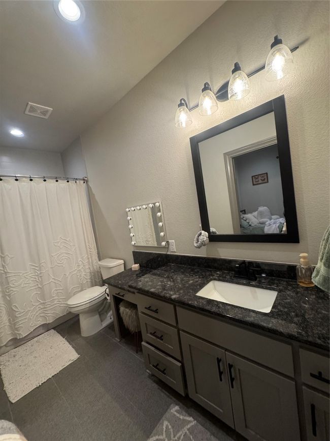 Bathroom featuring vanity, toilet, recessed lighting, a shower with curtain, and visible vents | Image 13