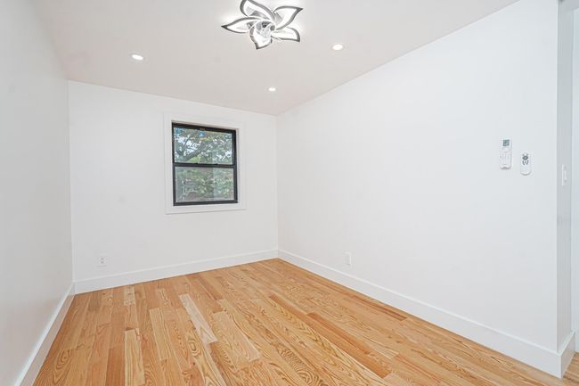 Empty room featuring light wood-style floors and recessed lighting | Image 6