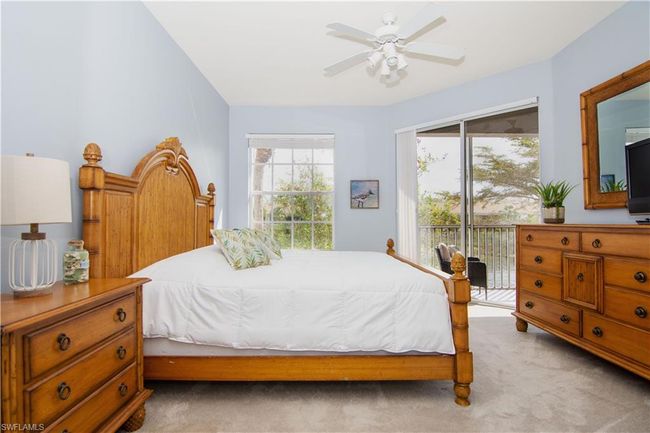 Primary Bedroom suite features plush wall to wall carpeting and a sliding door with direct entry to the screened lanai. | Image 12