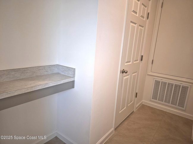 shelf in hall between garage and laundry | Image 22