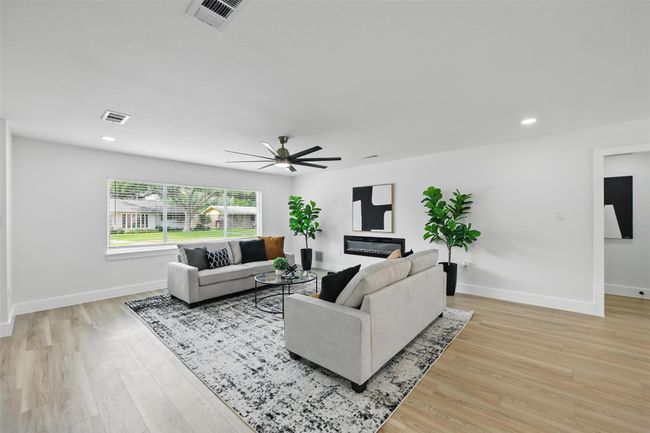 Living room featuring ceiling fan, light wood-style floors, baseboards, and recessed lighting | Image 7
