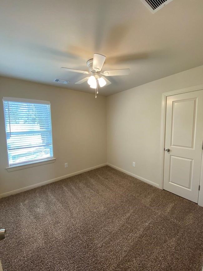 Spare room featuring carpet, a ceiling fan, and baseboards | Image 7