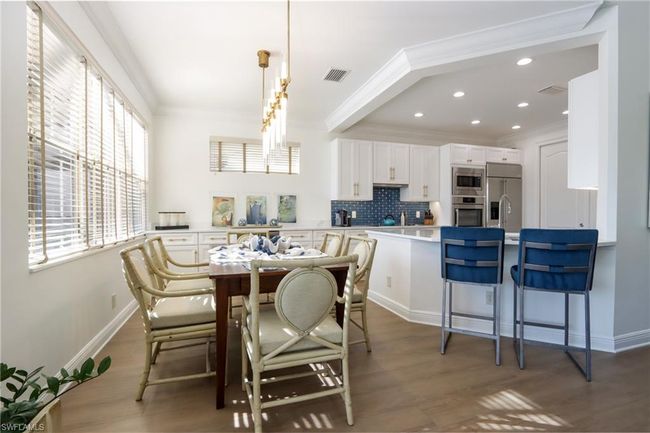 Dining room featuring crown molding, wood finished floors, and recessed lighting | Image 5