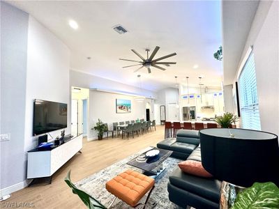 Living room featuring light hardwood / wood-style flooring and ceiling fan | Image 3