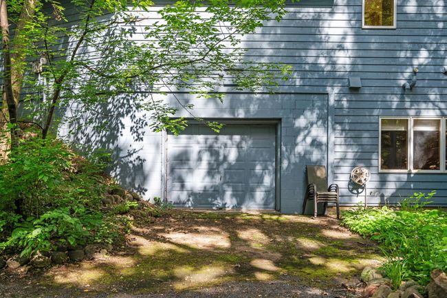 The lower level garage is great for car enthusiasts. Or use it for extra storage or gym. | Image 38