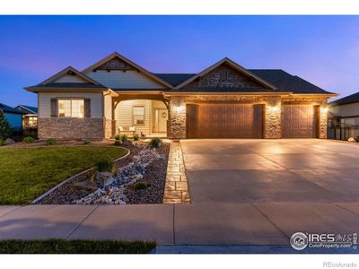 Beautiful Ranch-Style home in Dakota Glen, a community bordering Boedecker Lake. This home has curb appeal galore! The exterior features decorative stone, cedar shakes, and a covered front porch with exposed beams and overhead lights. | Image 1