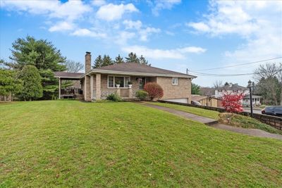 Large front yard with parking available on the side of the house | Image 1