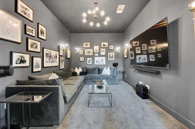 Cinema room featuring carpet floors and a chandelier | Image 8