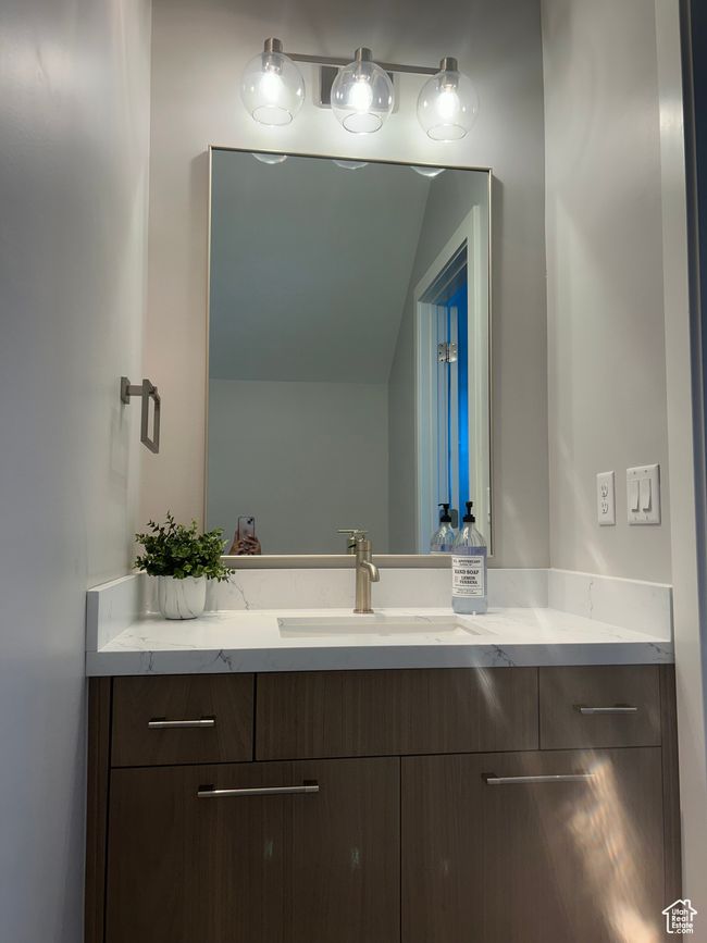 Bathroom featuring vanity and vaulted ceiling | Image 28