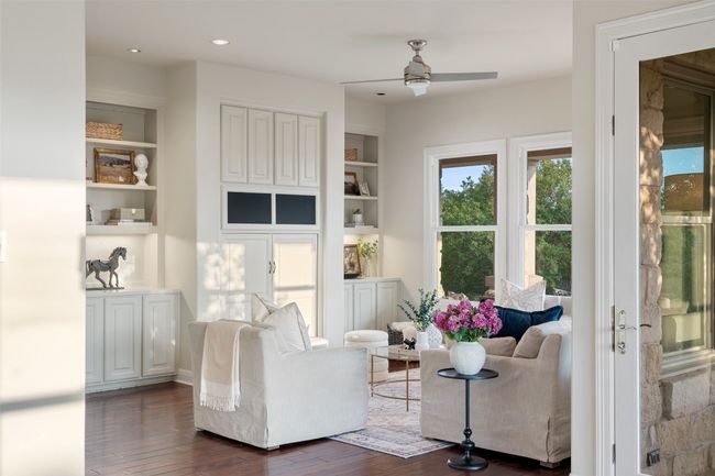 Living area with ceiling fan, built in features, dark wood-style flooring, and recessed lighting | Image 11