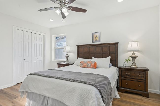 Bedroom with wood finished floors, a closet, baseboards, recessed lighting, and ceiling fan | Image 20