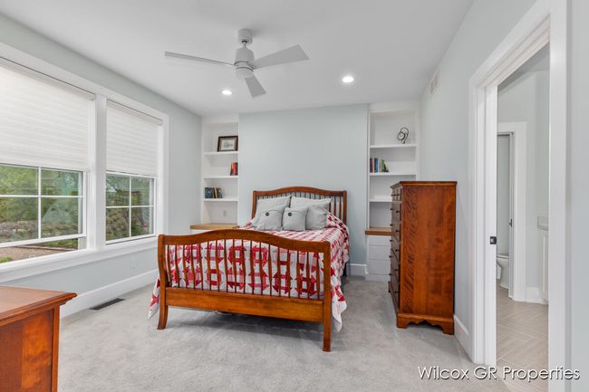 Gracious primary suite with 9' ceilings, beautiful, wooded views, and 9' ceilings. | Image 24