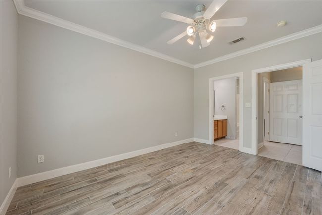 Bedroom 1 with en suite bath, and ceiling fan | Image 7