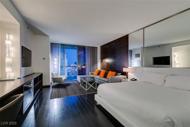 Bedroom featuring dark wood finished floors and a wall of windows | Image 8