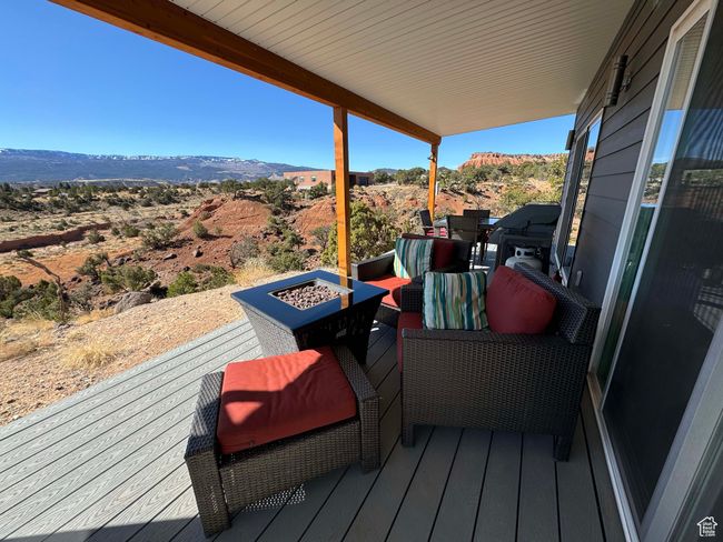 Deck with an outdoor fire pit and a mountain view | Image 29