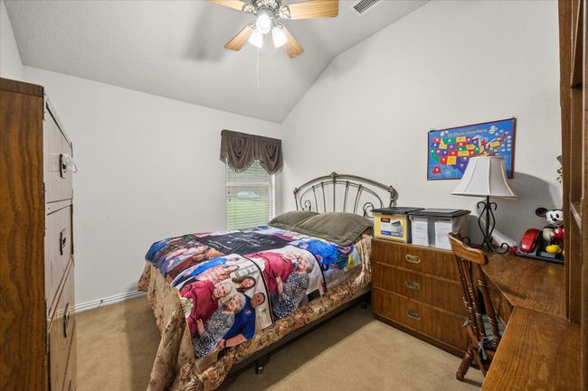 Bedroom with light carpet, vaulted ceiling, and a ceiling fan | Image 26