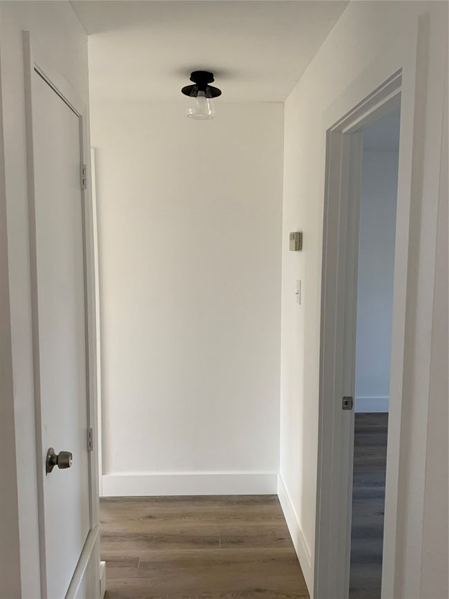 Hall featuring wood finished floors and baseboards | Image 19
