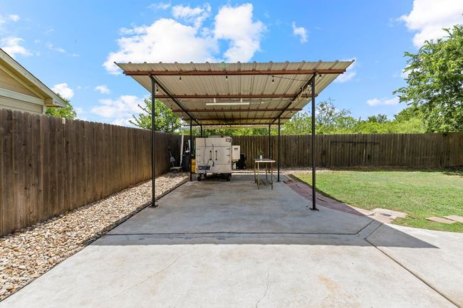 Fenced backyard with a patio area | Image 35