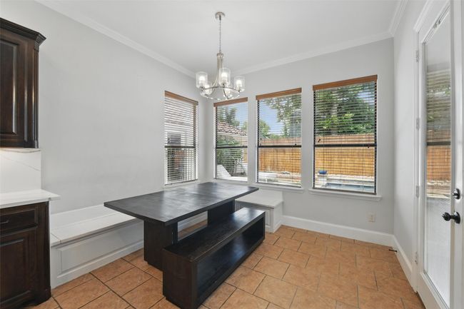 Large eat in kitchen area with built in bench for extra seating. | Image 16