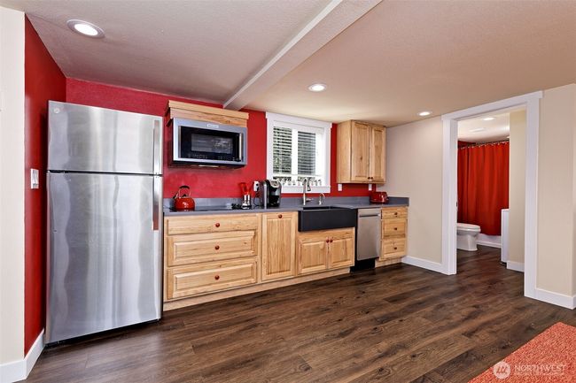 Kitchen and main level full bath with laundry included. | Image 15