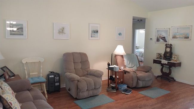 Living room with wood finished floors and baseboards | Image 4