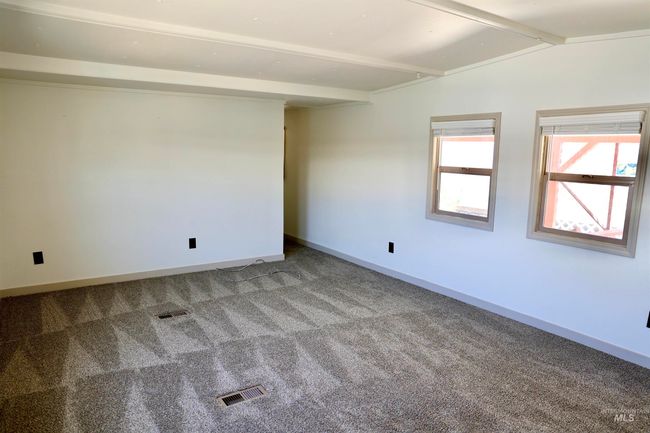 Carpeted spare room featuring baseboards | Image 5