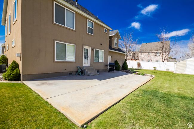 Rear view of house featuring a patio, crawl space, a yard, entry steps, and fence | Image 38