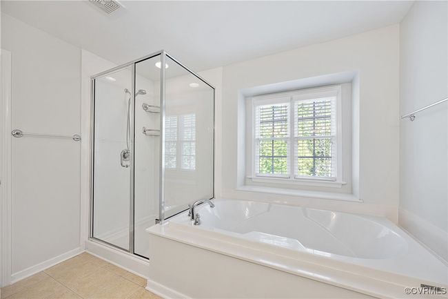 Full bath with tile patterned floors, visible vents, a stall shower, and a soaking tub | Image 40