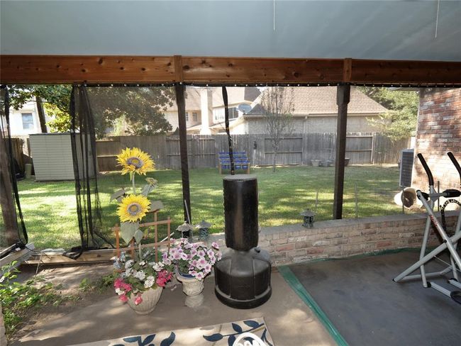Covered patio with back yard view | Image 29