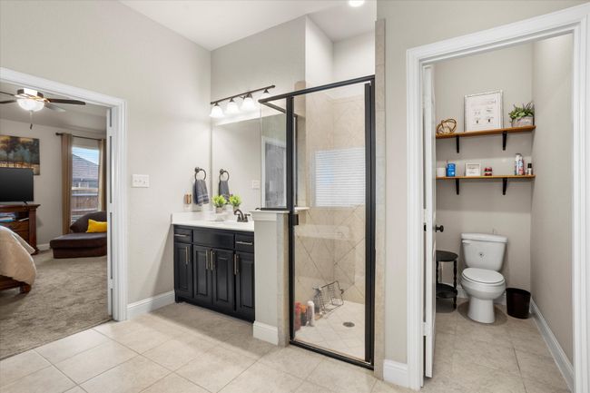 Full bath featuring toilet, a shower stall, ensuite bath, and vanity | Image 23