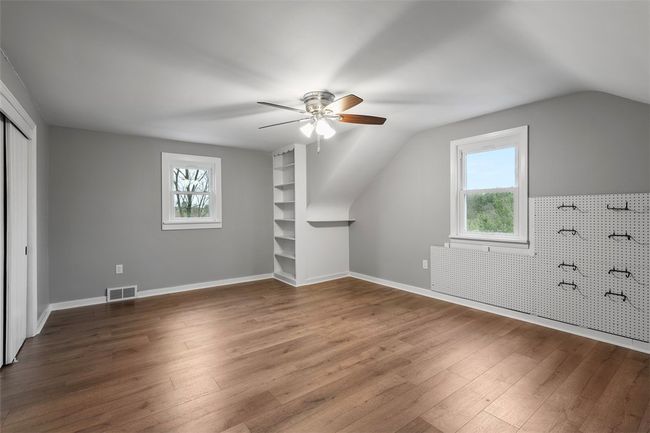 Bedroom 4: A large closet and built in shelving provide ample storage, while the windows and overhead light add brightness to this room. | Image 24
