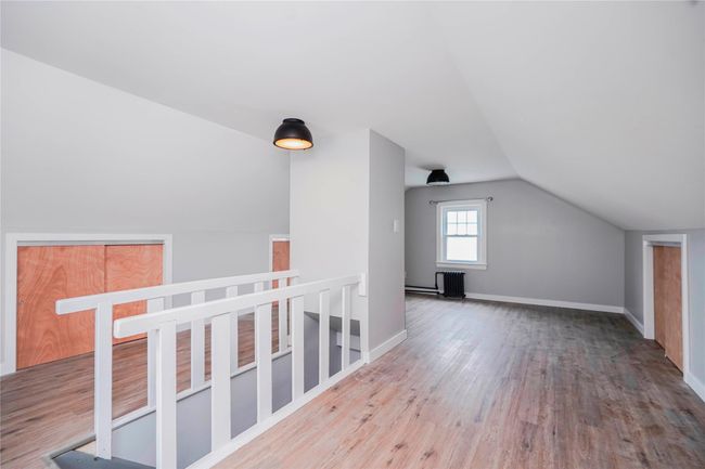 Additional living space featuring baseboards, wood finished floors, and lofted ceiling | Image 27