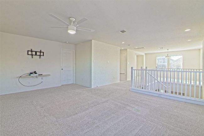 Unfurnished room featuring a ceiling fan, light colored carpet, and recessed lighting | Image 25