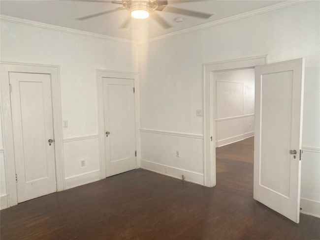 Unfurnished 2nd room featuring wood finished floors, crown molding, and ceiling fan | Image 10