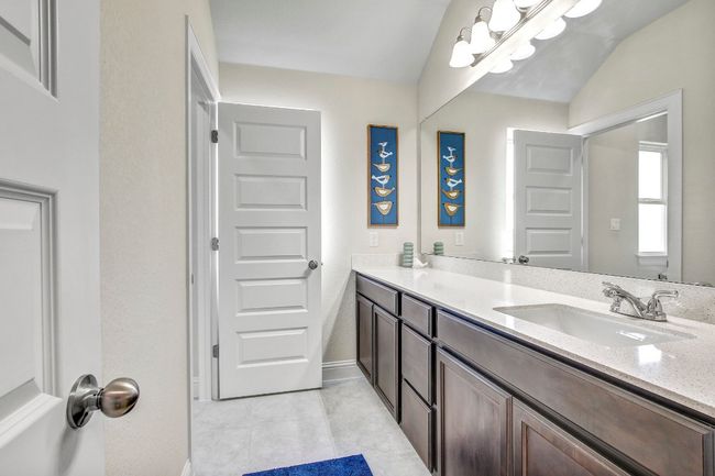 Bathroom featuring vanity, tile patterned floors, and vaulted ceiling | Image 32