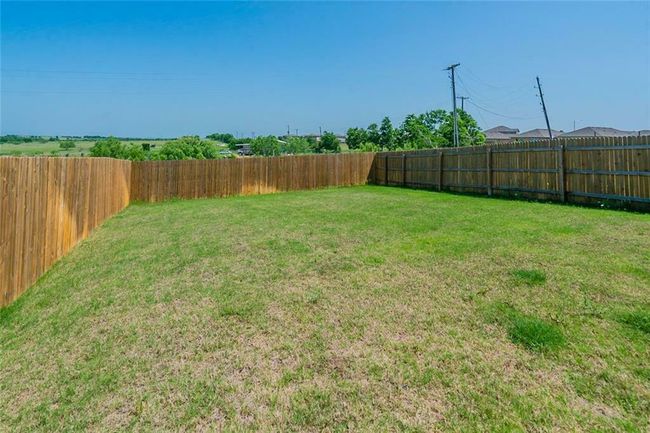 View of fenced backyard | Image 21
