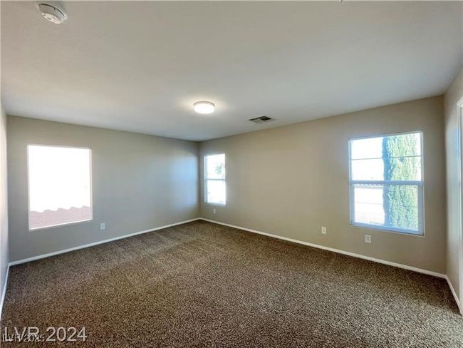 Spare room with dark colored carpet and baseboards | Image 9