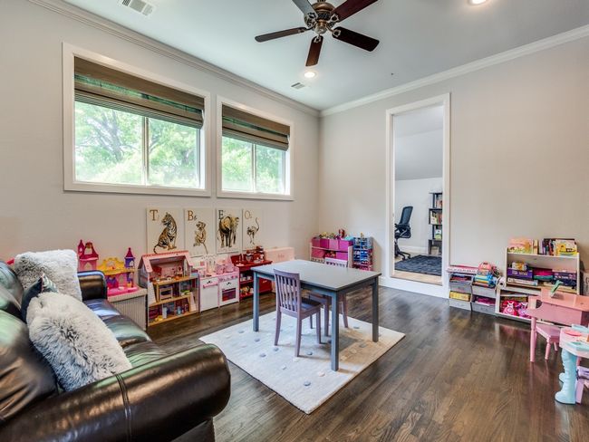 Playroom featuring ornamental molding, dark wood-type flooring, ceiling fan, and recessed lighting | Image 17